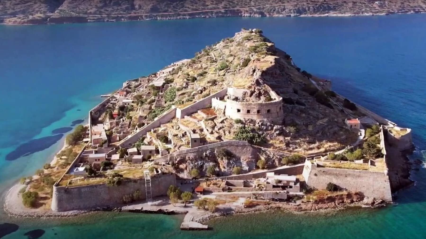 Spinalonga, the iconic fortress island of Crete, overlooking turquoise waters and well-preserved ruins – an ideal destination for cultural and historical tourism in Greece.